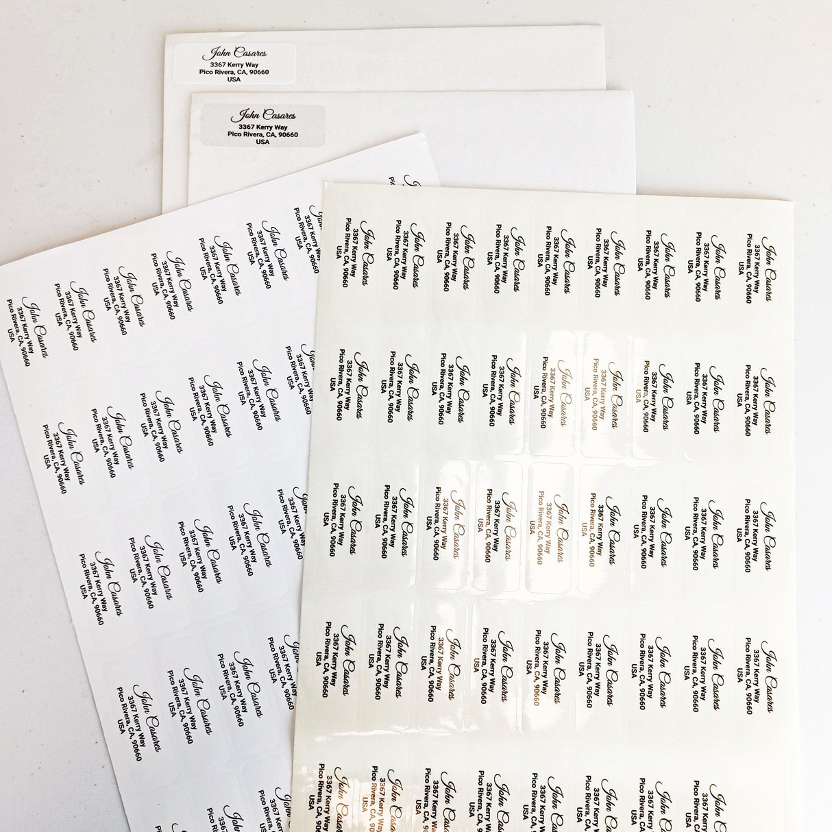 Custom clear address labels on sheets, featuring personalized names for mailing and shipping.