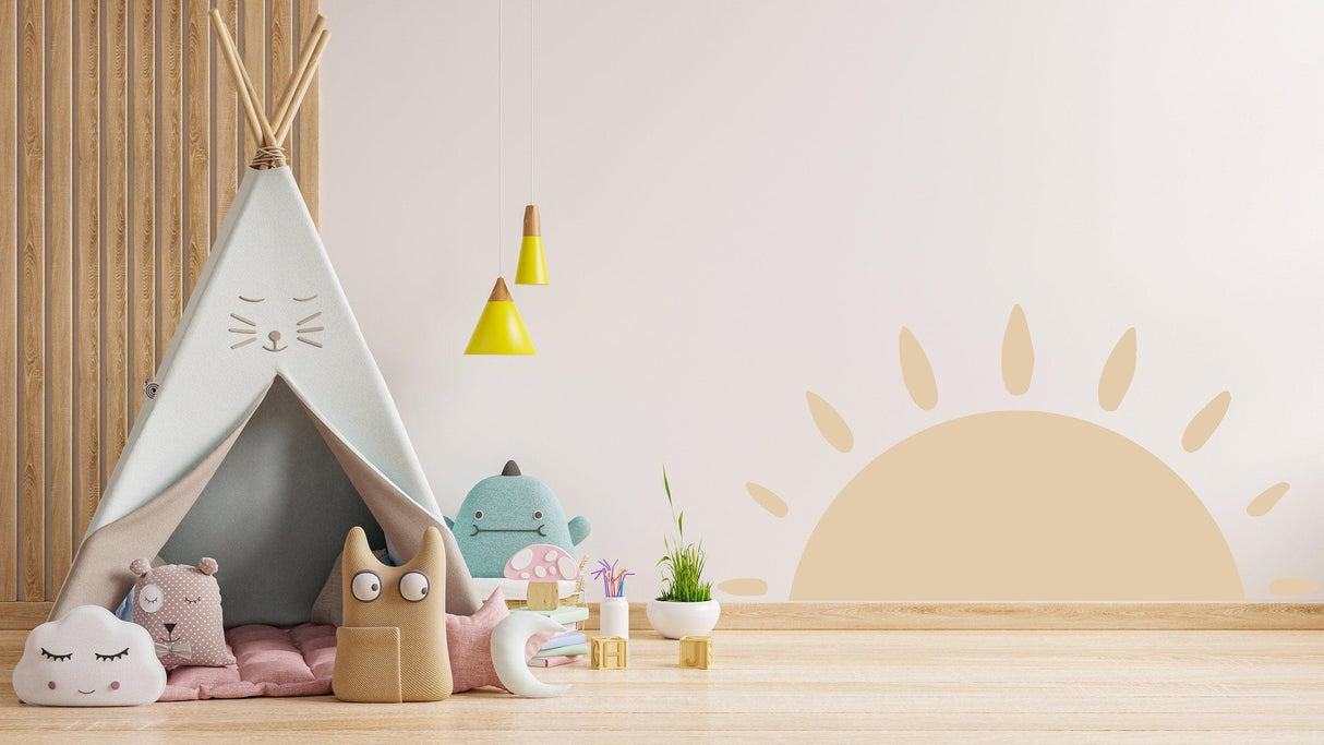 Cozy nursery with Boho sun wall decal, kids' toys, and a teepee for a whimsical decor vibe.