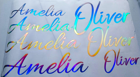 Personalised vinyl name decals featuring the names Amelia and Oliver in rainbow holographic finish.