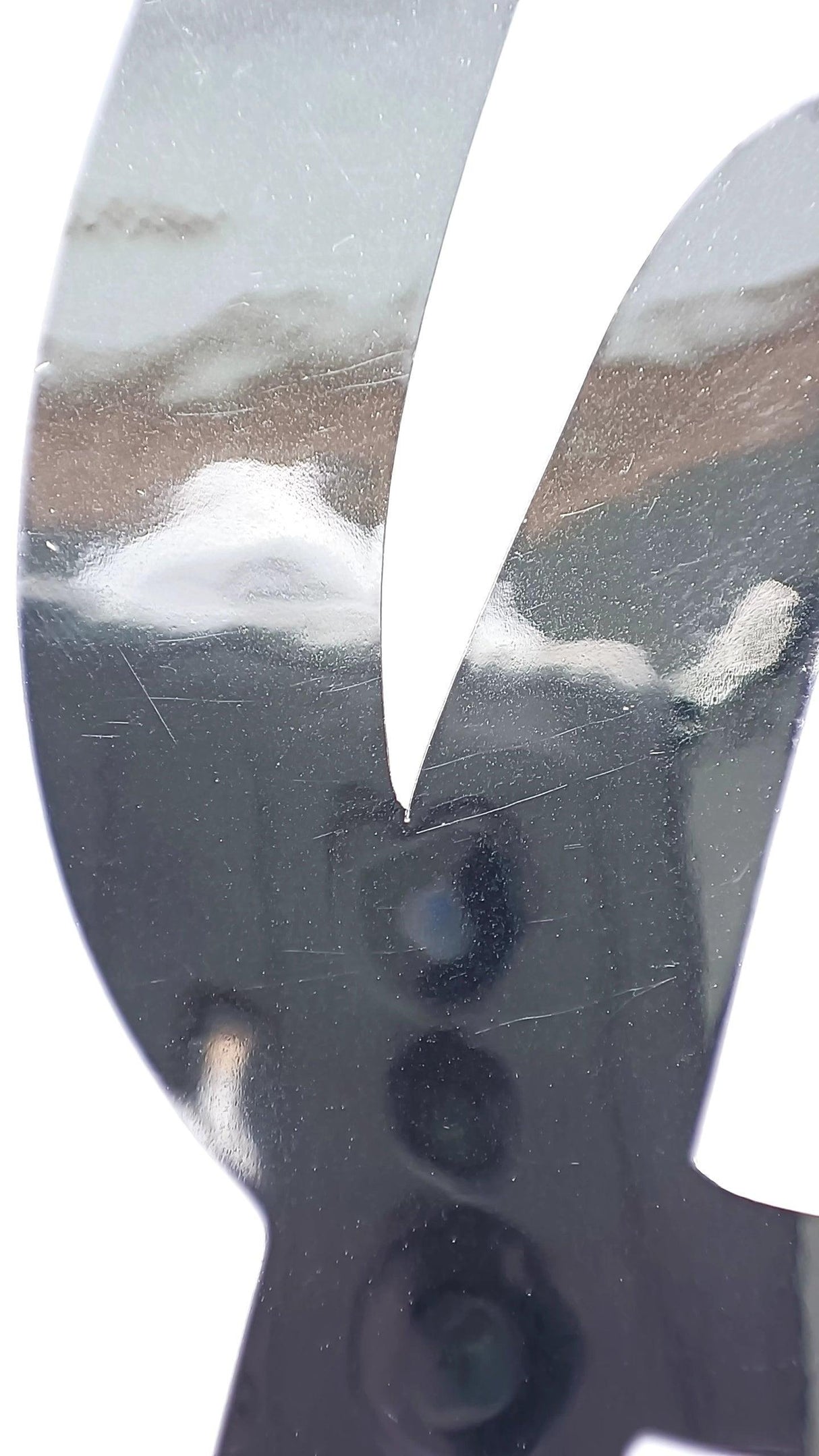 Close-up of shiny silver chrome vinyl name sticker showcasing its reflective surface and sleek design.