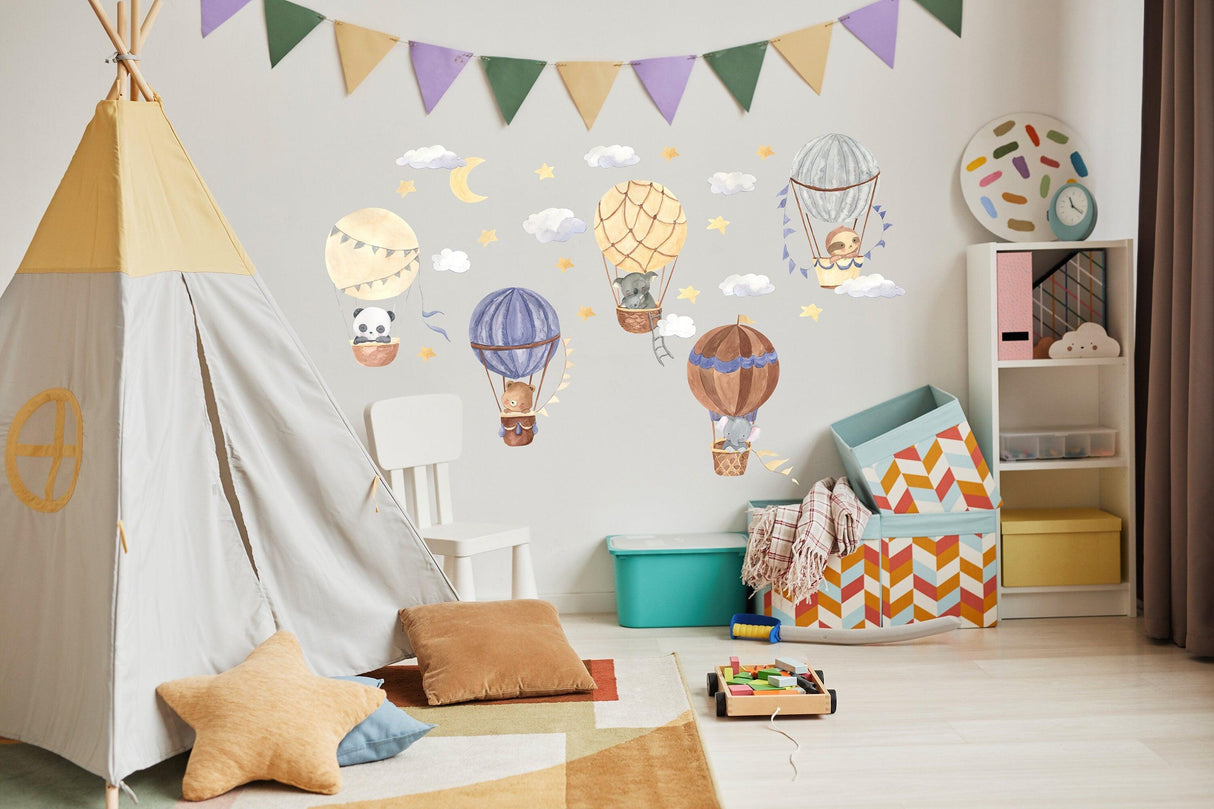 Colorful hot air balloon wall stickers with animals and clouds in a cozy nursery setting.