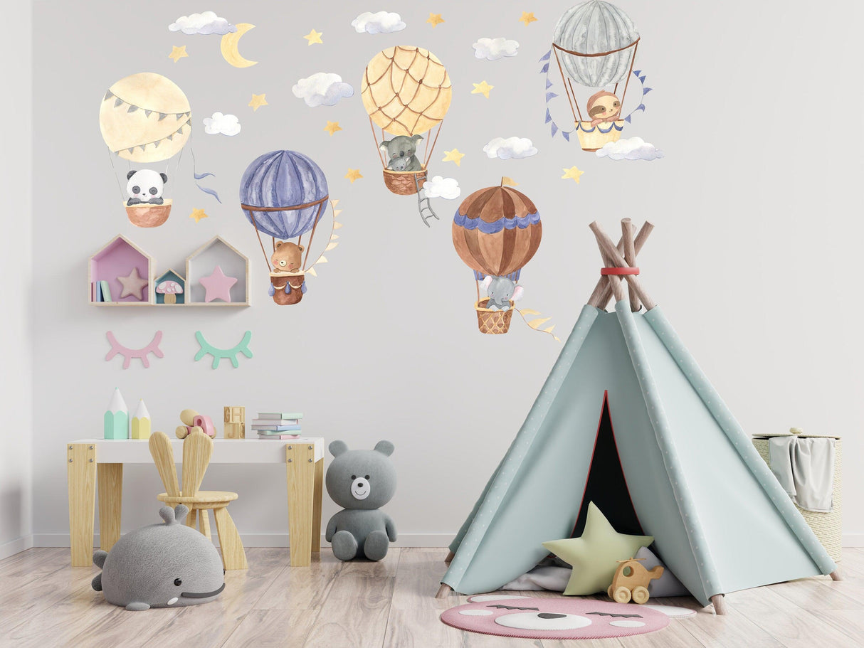 Colorful hot air balloon wall stickers with animals and clouds in a cozy nursery setting.