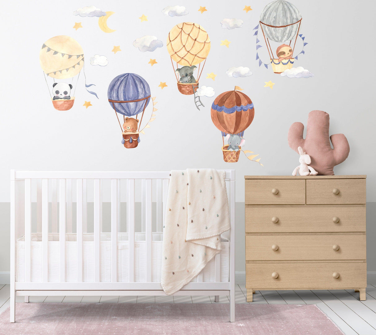 Hot air balloon wall stickers with whimsical animals in a nursery setting, featuring stars and clouds.