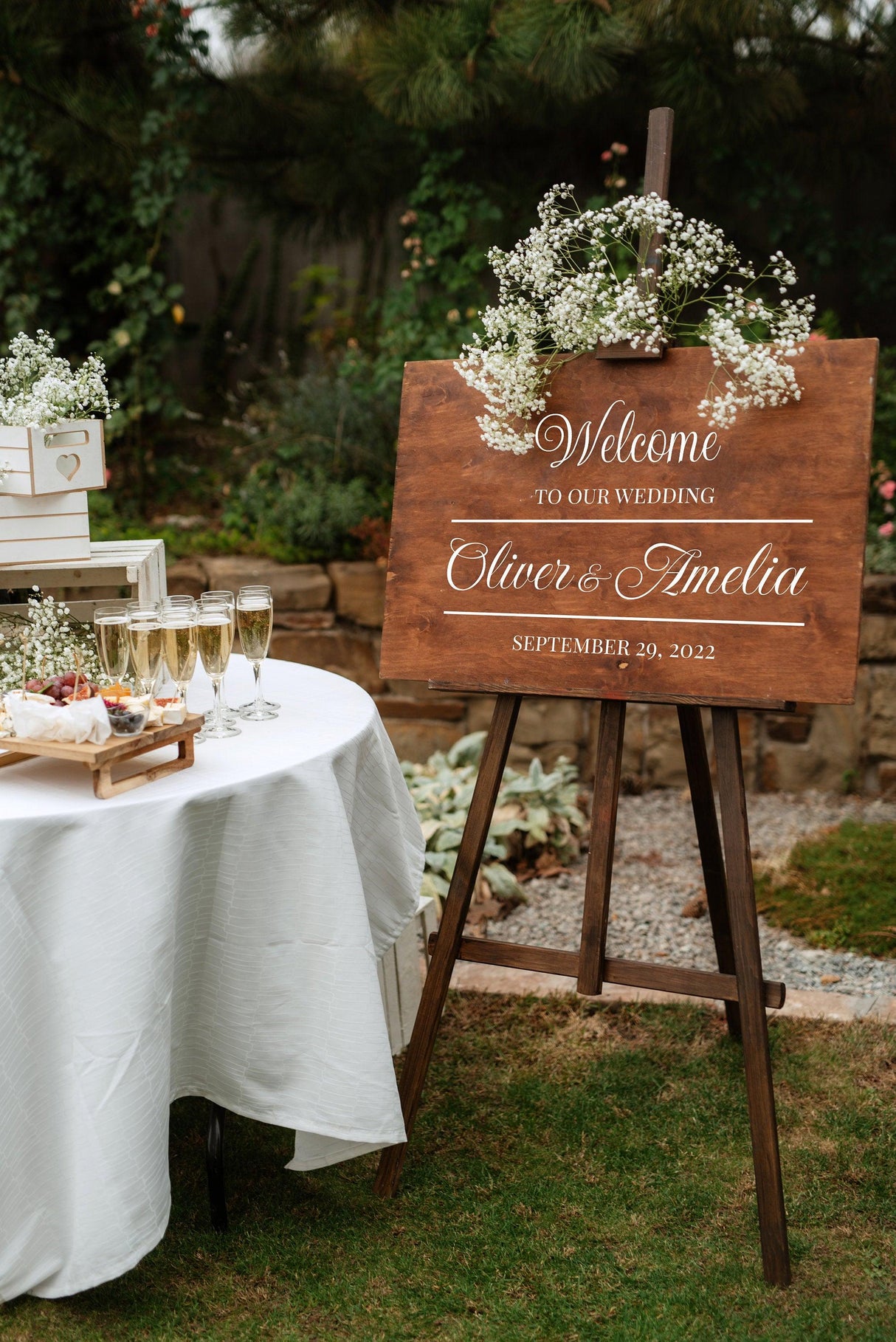 Welcome to our wedding sign featuring names Oliver & Amelia with a floral arrangement, elegant decor for a wedding ceremony.