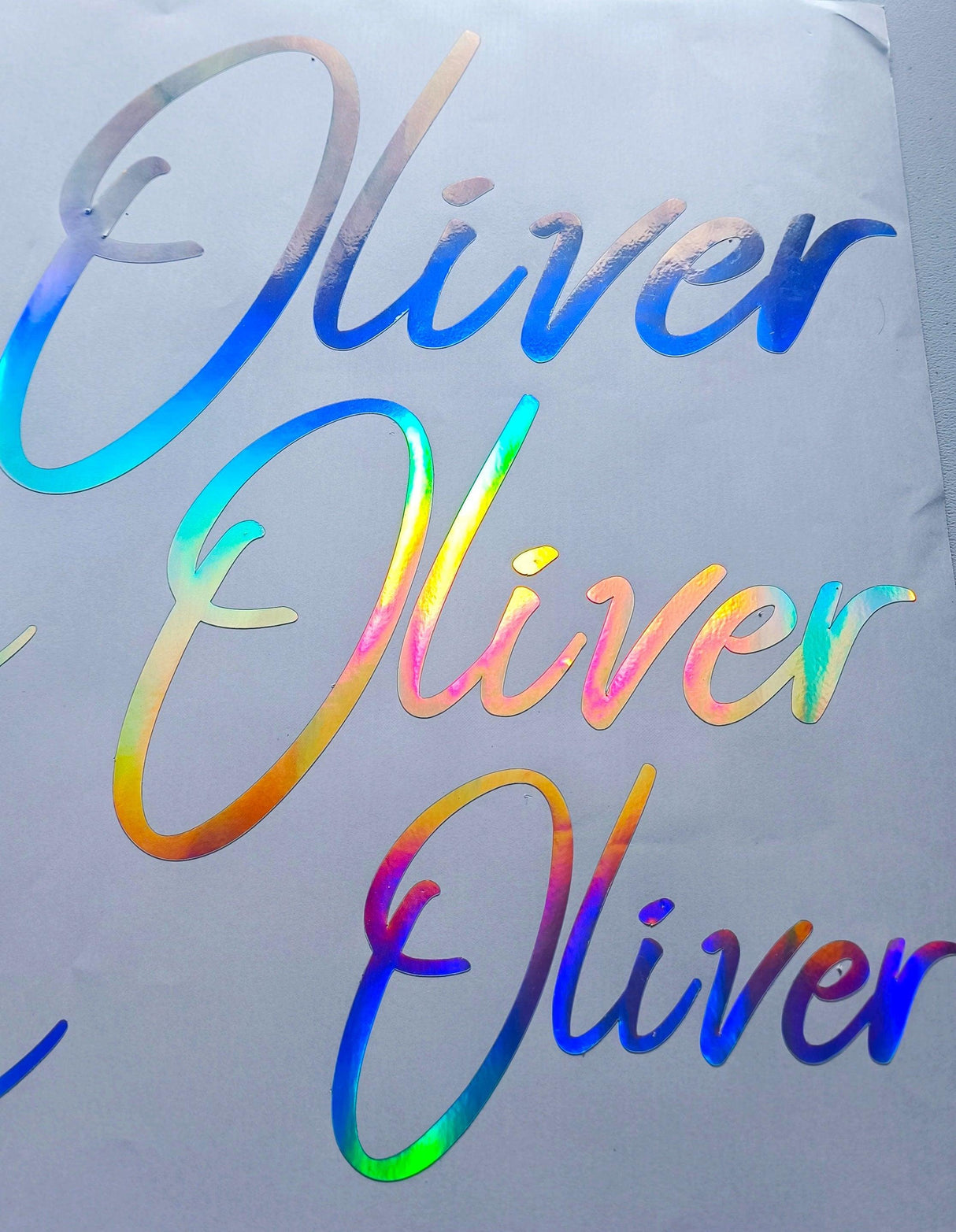Personalized rainbow holographic name decal featuring the name 'Oliver' in stylish lettering.