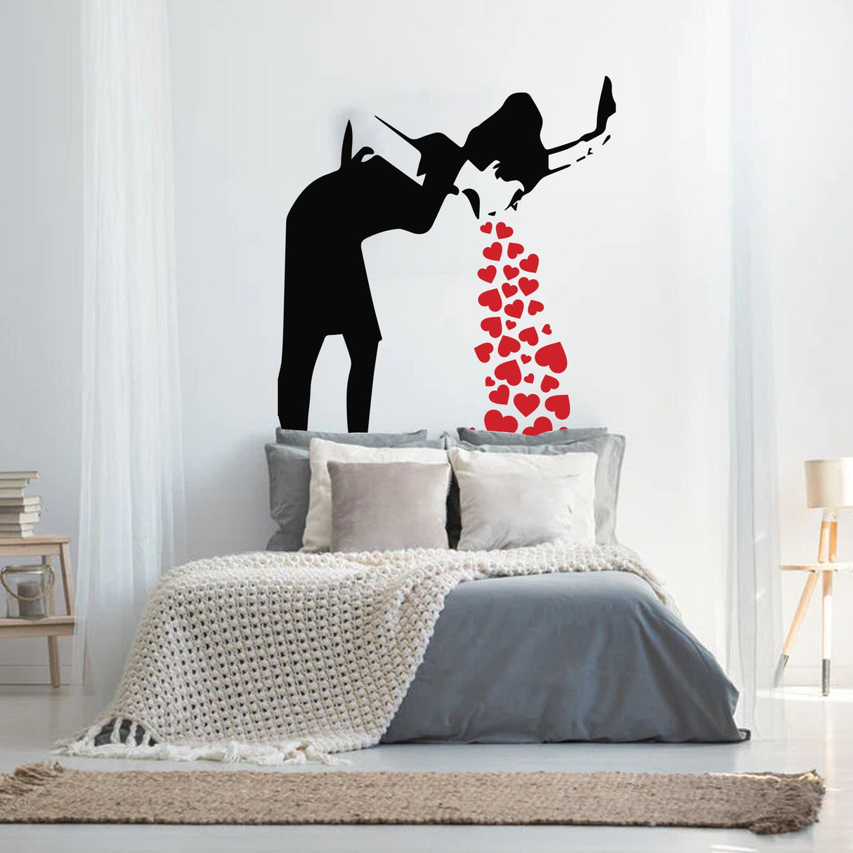 Banksy lovesick girl wall decal with red hearts above her, creating a bold urban art statement in a bedroom.