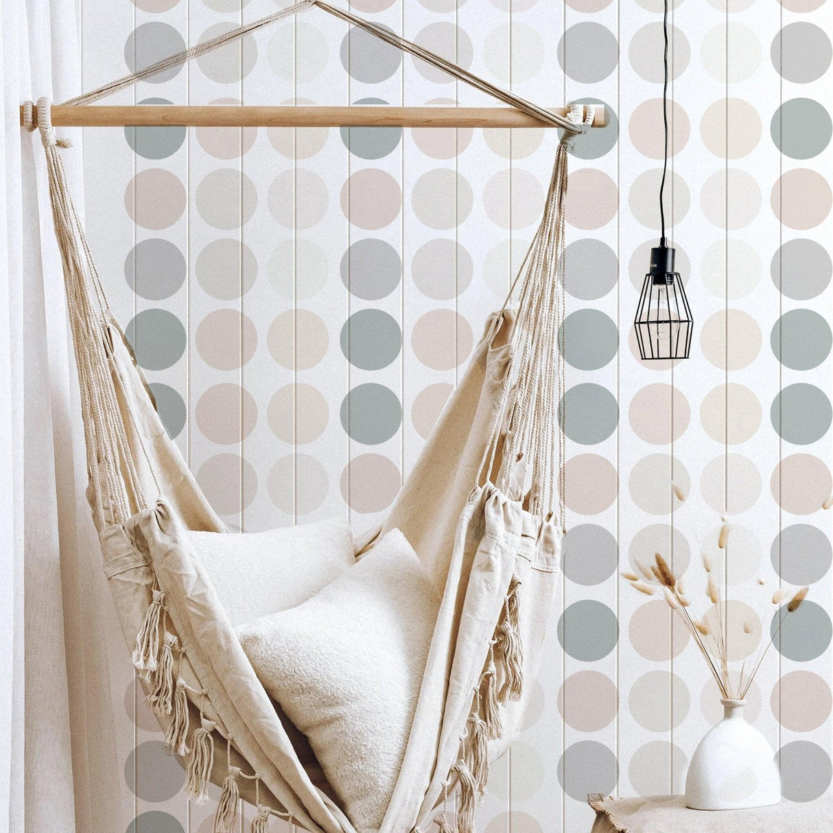 Cozy hammock in a nursery room with pastel boho dot wall stickers and modern decor accents.