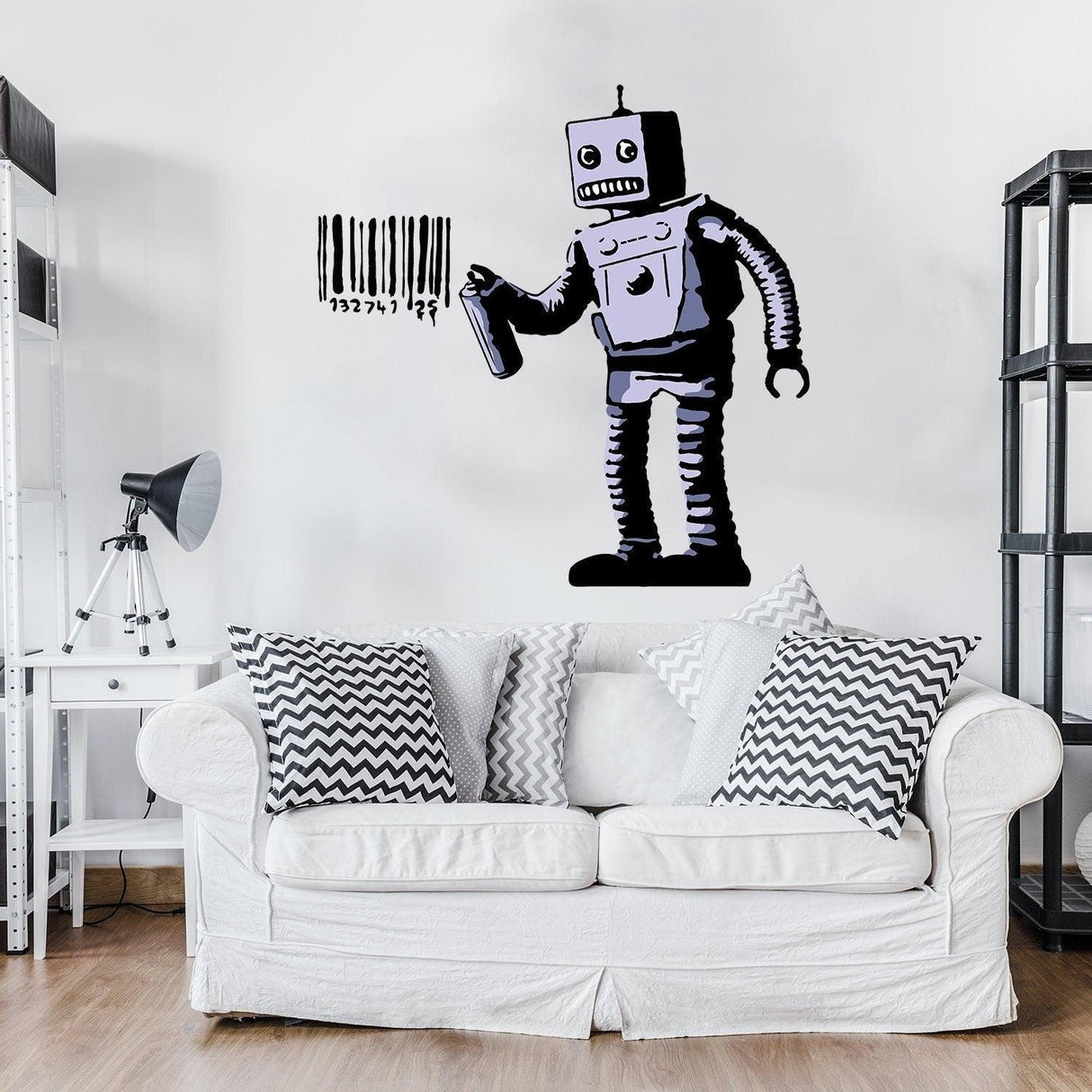 Banksy Barcode Robot Wall Vinyl Sticker on a white wall above a sofa, showcasing urban street art style.