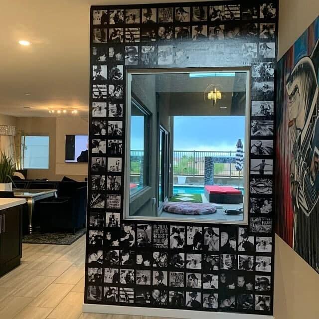 Stylish custom wall decal gallery with black and white photos framing a large window in a modern home interior.