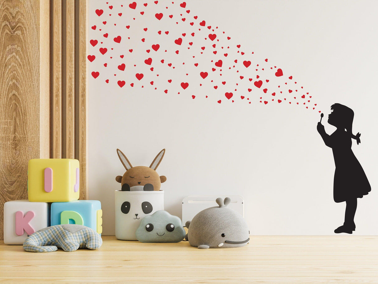 Heart Bubbles Girl wall sticker blowing heart-shaped bubbles, adding a playful touch to a children's room.