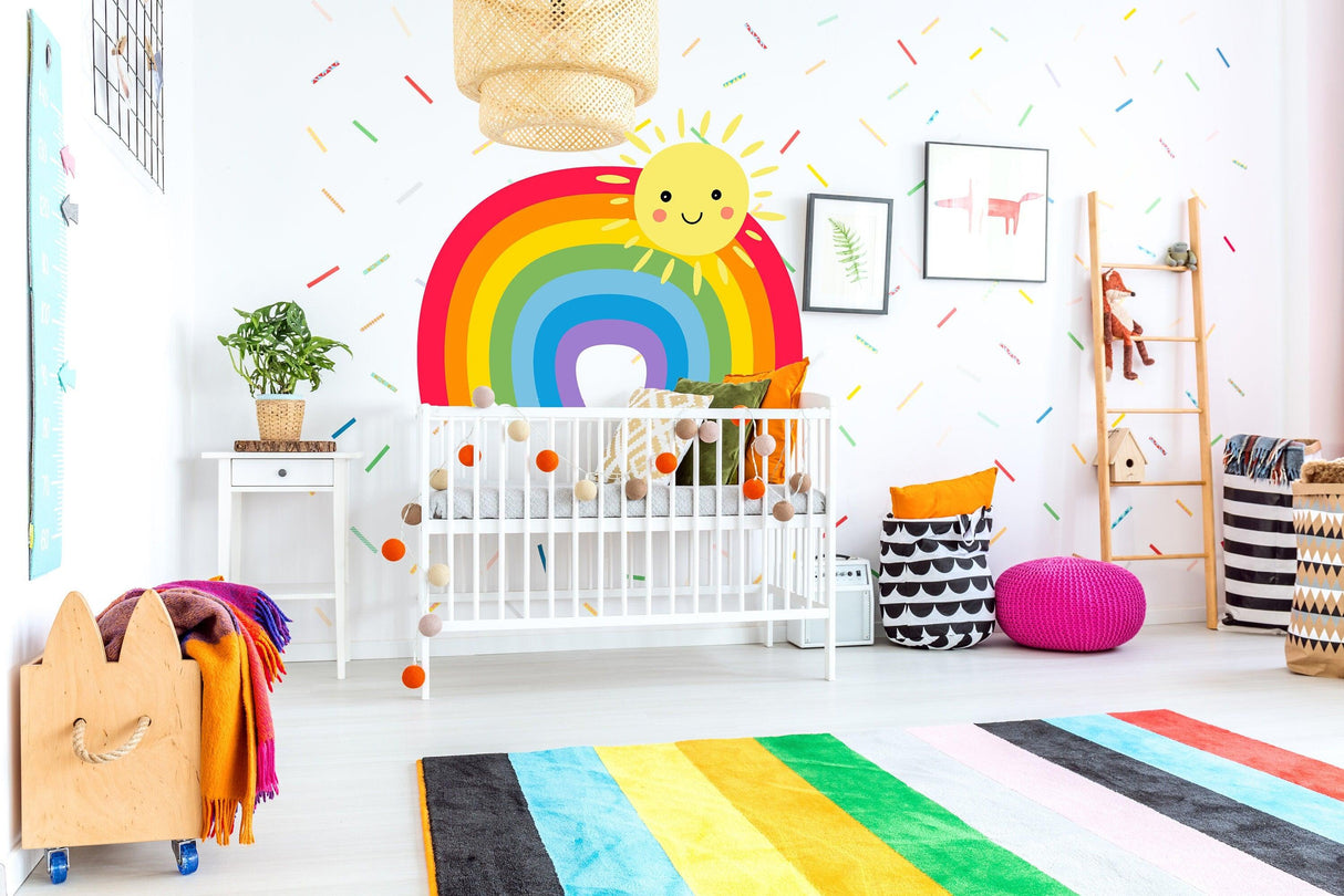 Colorful nursery with a rainbow wall sticker and playful decor for baby's room.