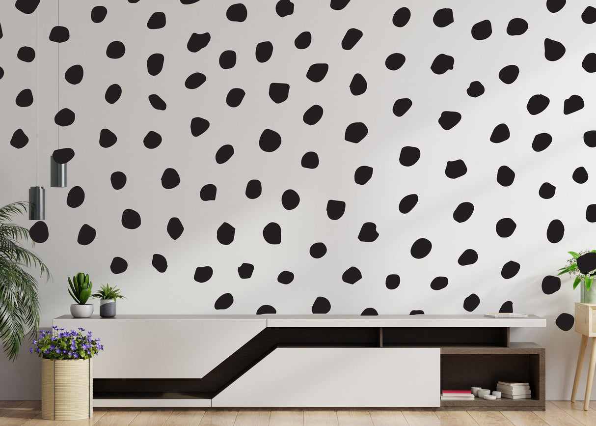 250x black polka dots wall decal on modern white wall, adding playful decor to a stylish room.
