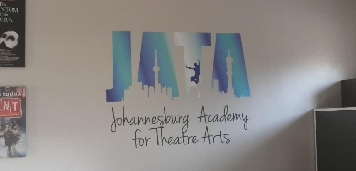 Custom wall decal of 'JATA' for Johannesburg Academy for Theatre Arts, showcasing artistic design on a studio wall.