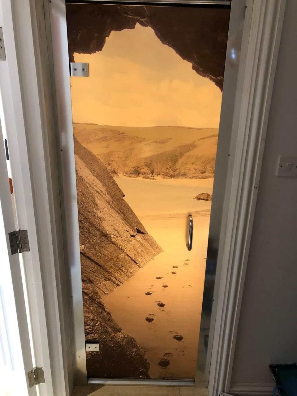 Beach scene door decal featuring footprints in the sand, bringing a serene coastal vibe to home decor.