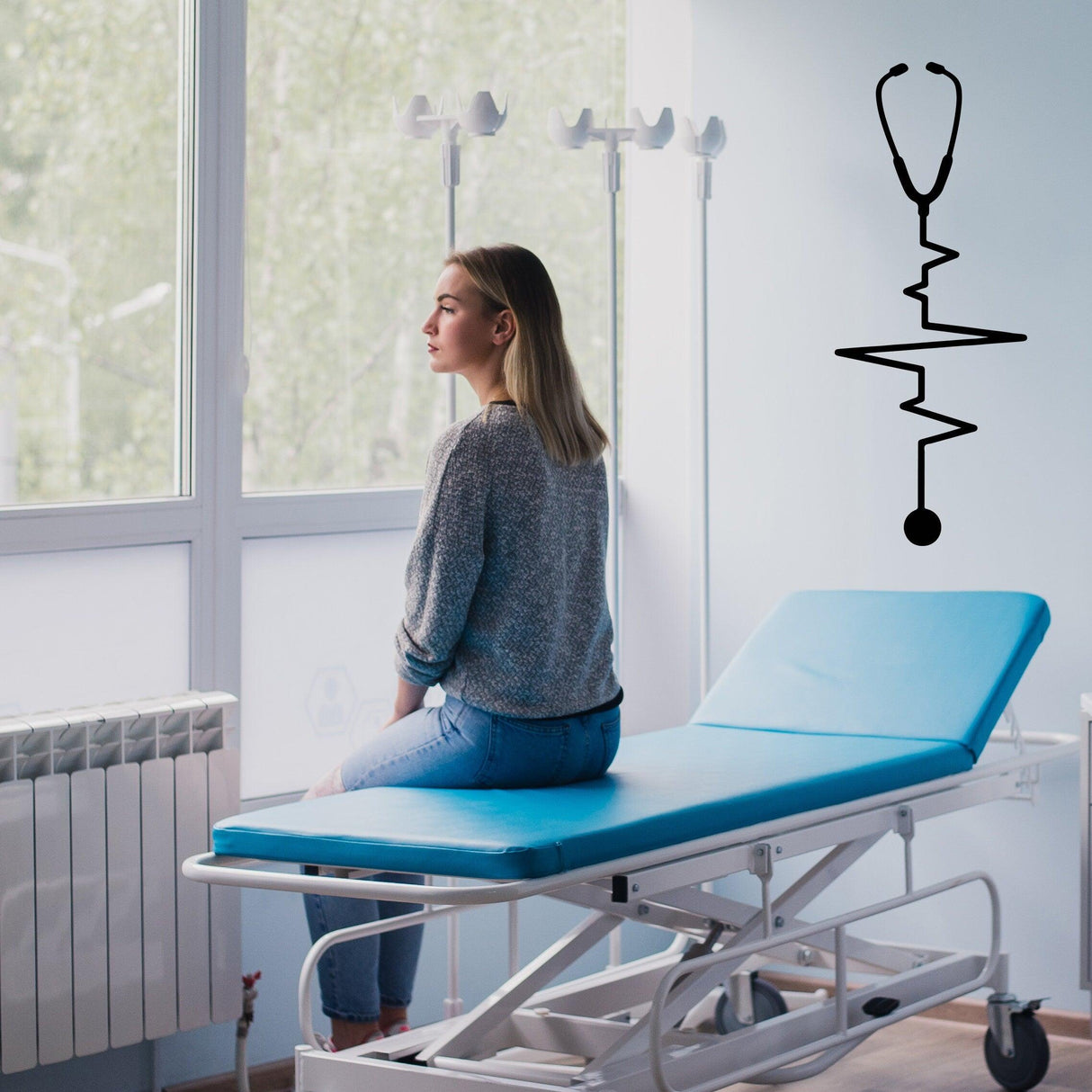 Woman sitting on a medical examination table with Emt Paramedic wall sticker in a clinic setting.