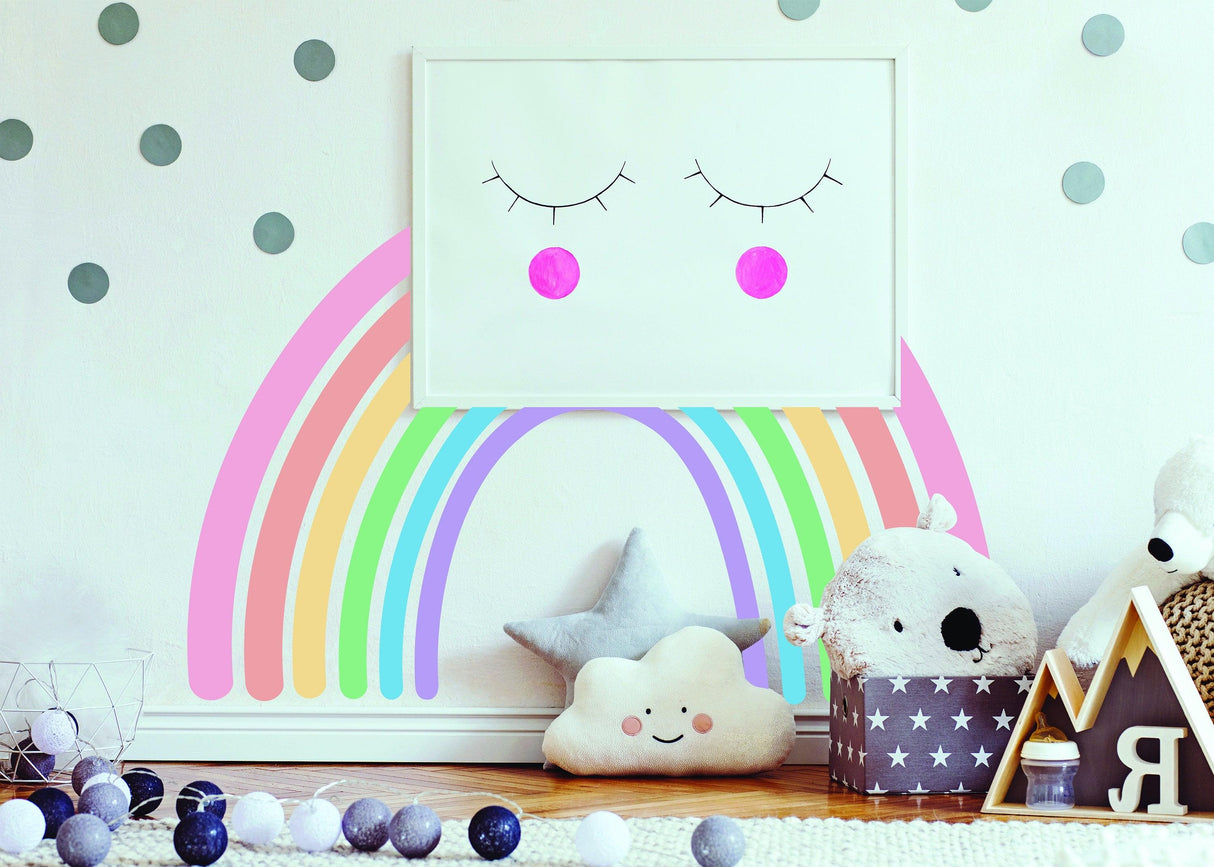 Pastel rainbow wall sticker in nursery with playful decor and toys, ideal for baby room boho style.