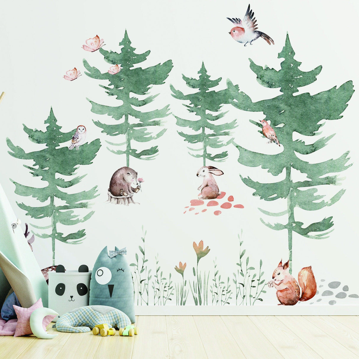 Whimsical woodland wall decal featuring trees and forest animals like rabbits, hedgehogs, and birds in a child's room.