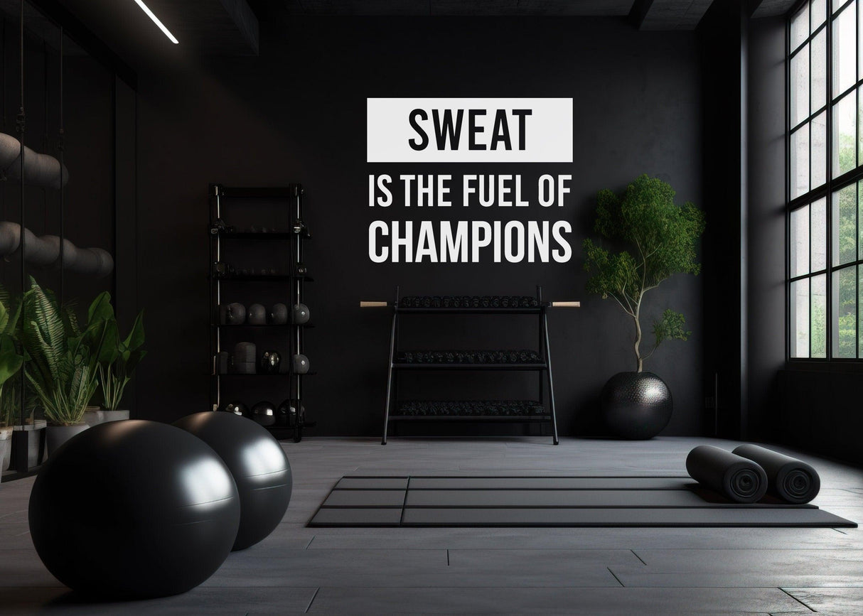 Gym interior with motivational wall decal 'Sweat is the Fuel of Champions', weights, and exercise mats for fitness enthusiasts.