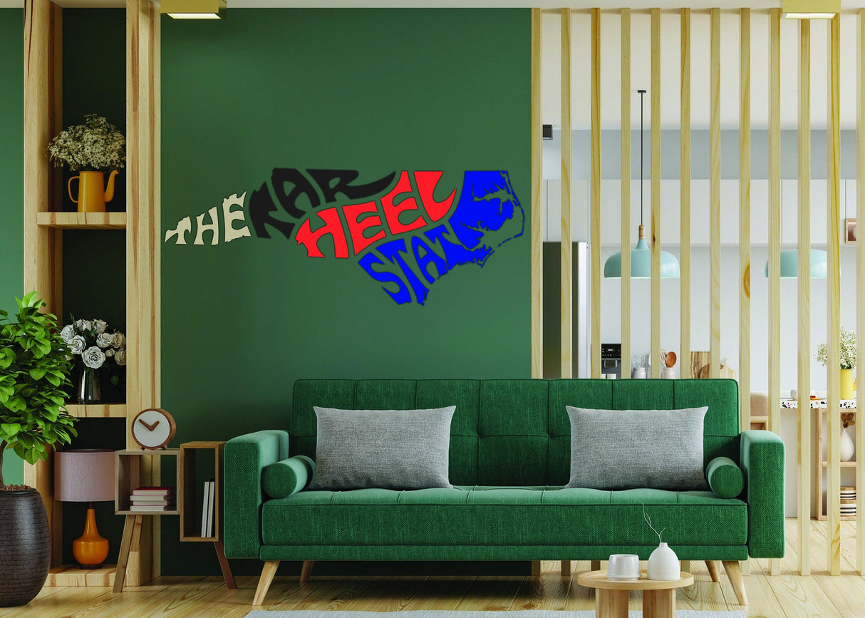 North Carolina vinyl decal featuring Tar Heel State design on a green wall above a modern sofa.