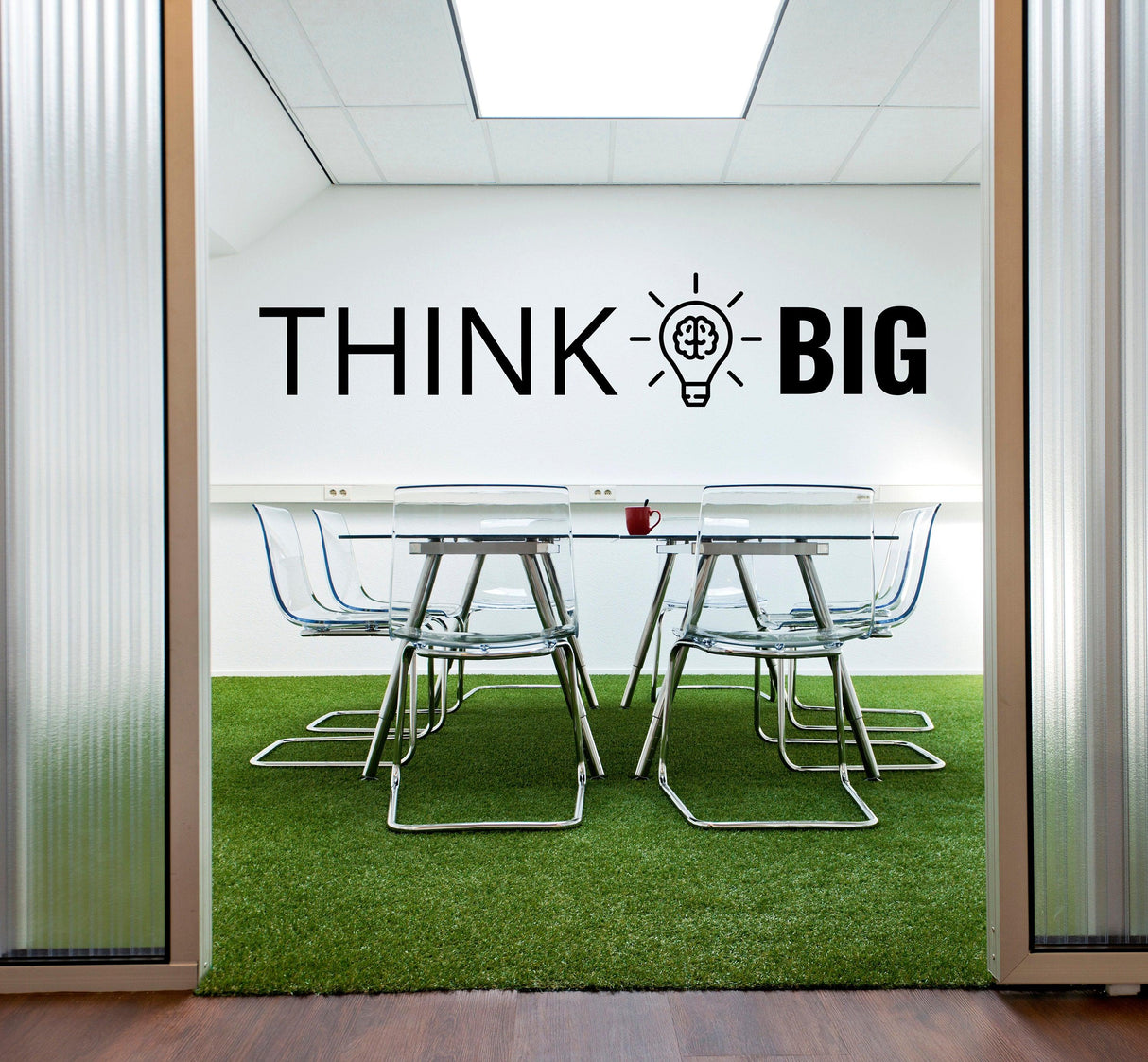 Office conference room featuring 'Think Big' motivational wall art sticker and modern chairs.