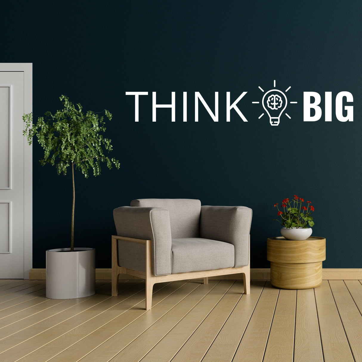 Modern office wall featuring 'THINK BIG' motivational decal above a cozy armchair and plants.