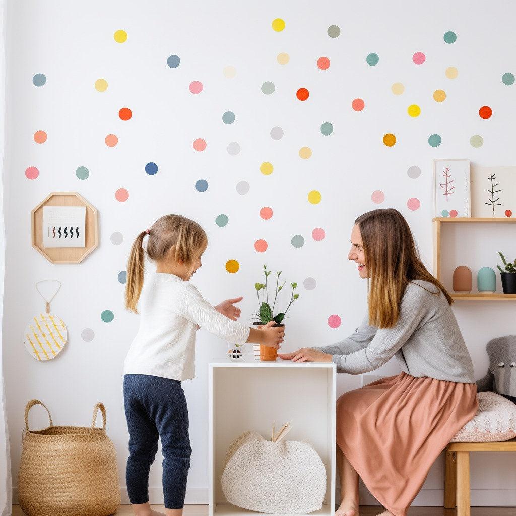 Kids enjoying a playful space with colorful round dot decals on the wall, showcasing a fun playroom atmosphere.