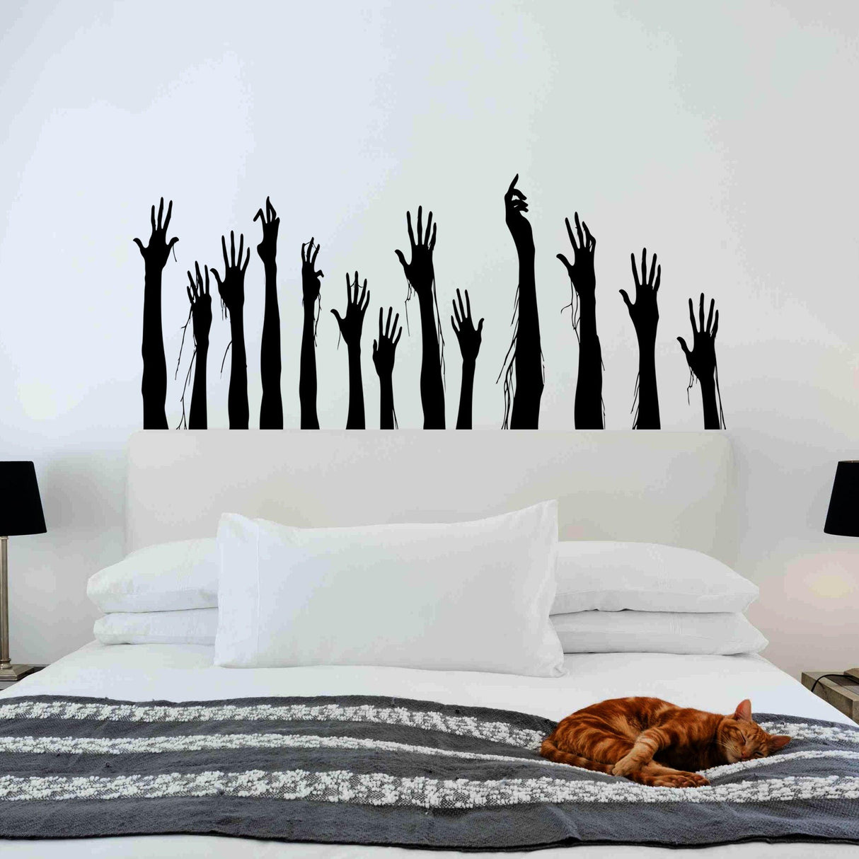 Creepy black zombie hands wall decal above a bed, perfect for Halloween home decor.
