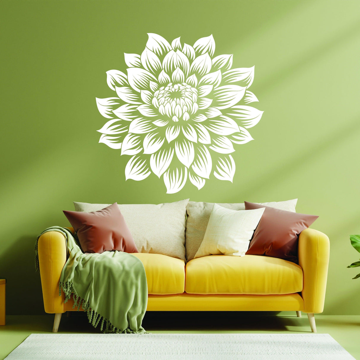 Large white flower wall decal on green wall above a yellow couch, adding elegance to home decor.