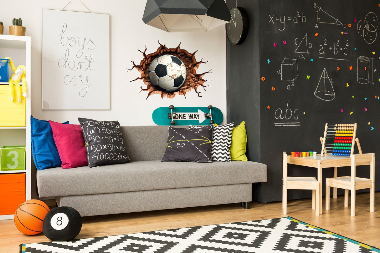 Stylish boys room with 3D football wall decal, colorful pillows, and playful decor elements.
