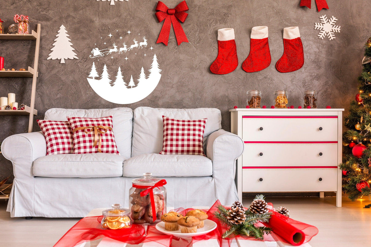 Cozy living room decorated for Christmas with Santa silhouette, red stockings, and festive treats on the table.