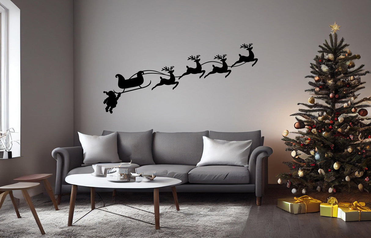 Humorous Santa and reindeer wall decal above a cozy living room with a Christmas tree and festive decorations.
