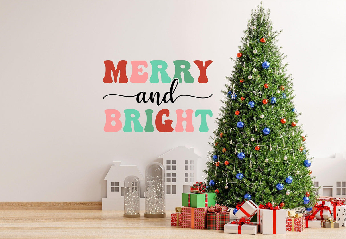 Colorful 'Merry and Bright' wall decal above a decorated Christmas tree and gifts in a festive living room.