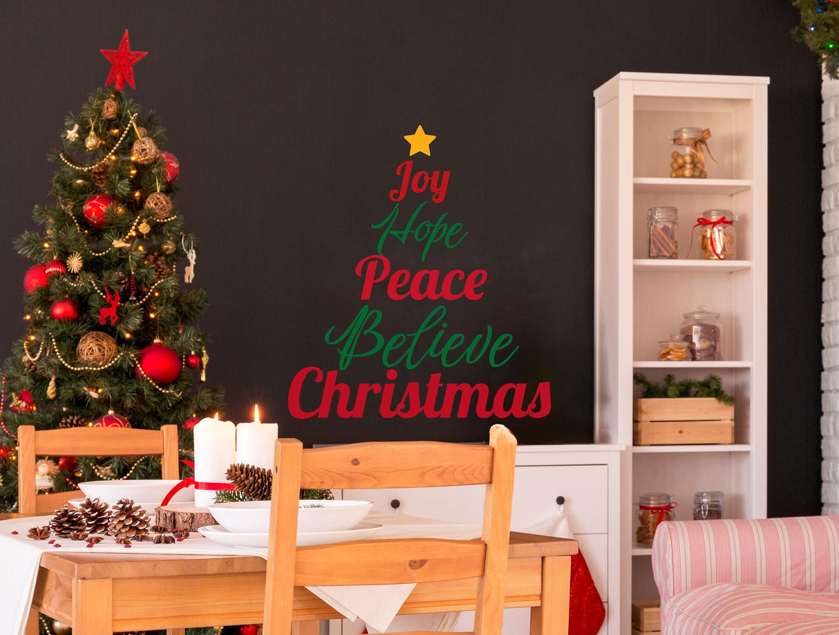 Colorful Christmas Quote Wall Decal on a dark wall, featuring 'Joy Hope Peace Believe Christmas' with festive decor.