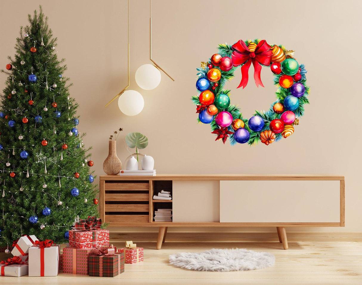 Colorful watercolor Christmas wreath wall decal with red bow, adorned with ornaments, next to a decorated tree.