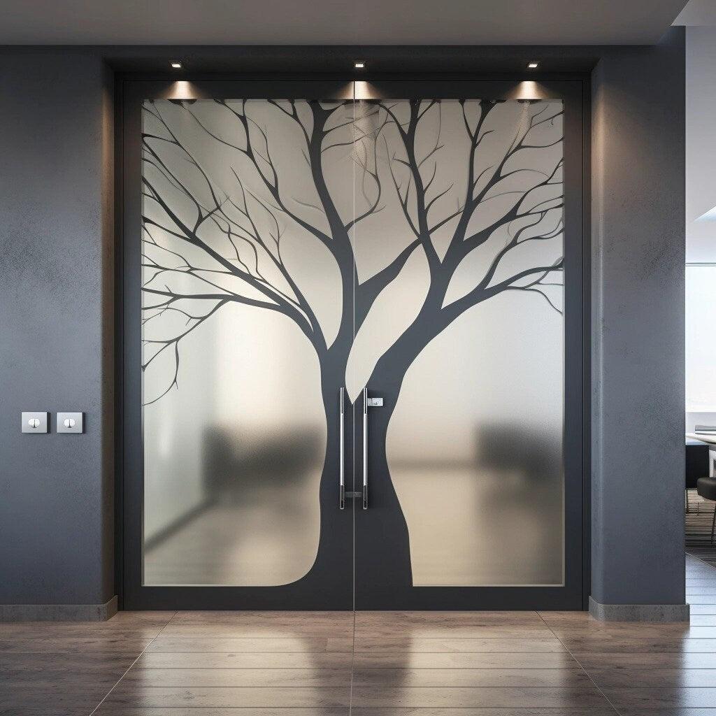 Frosted black tree silhouette decal on glass doors, enhancing privacy and modern decor.