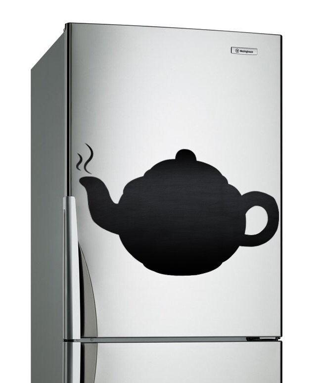 Vinyl decal of a teapot on a stainless steel refrigerator, adding a stylish touch to kitchen décor.