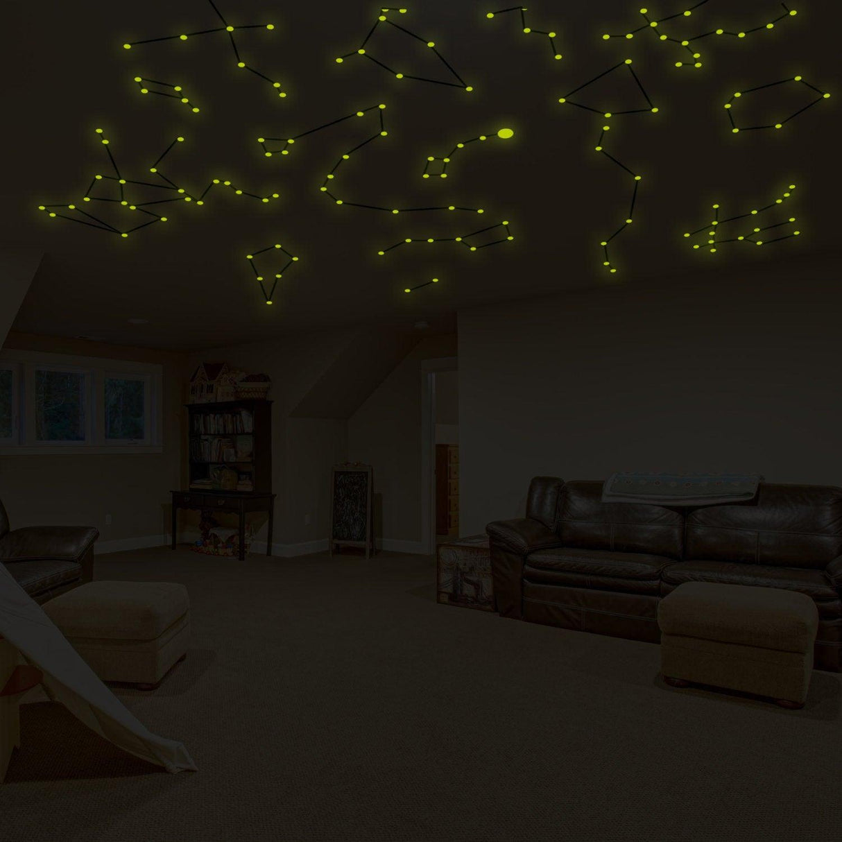 Glowing vinyl ceiling decal star map with color lines illuminating a cozy living room.