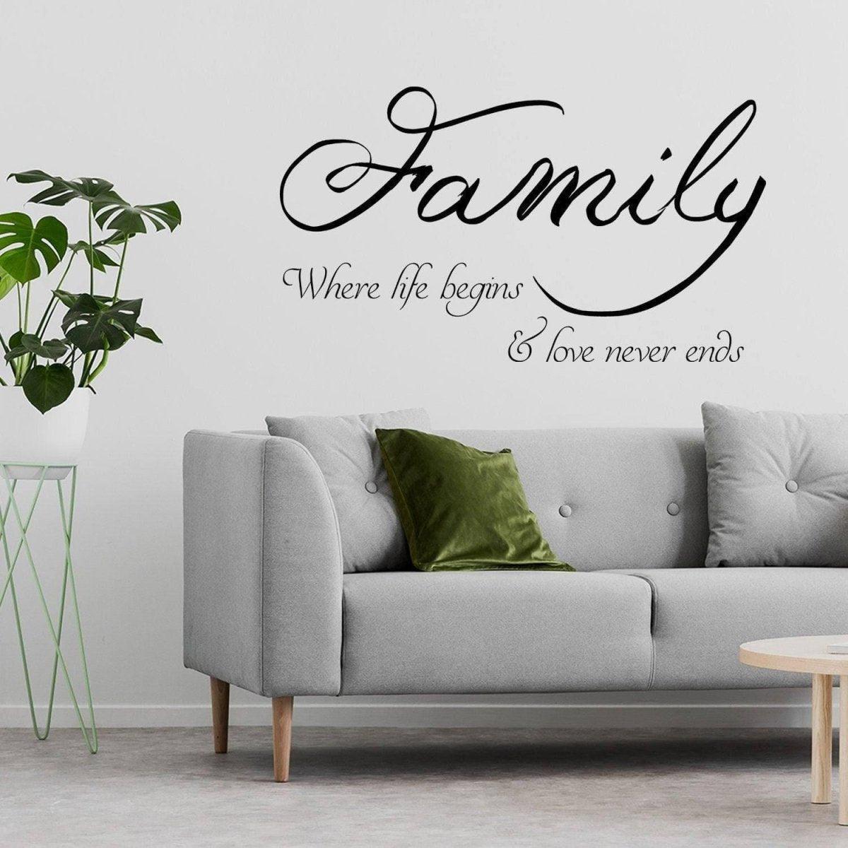 Motivational family wall decal "Family where life begins & love never ends" above a modern sofa with pillows.