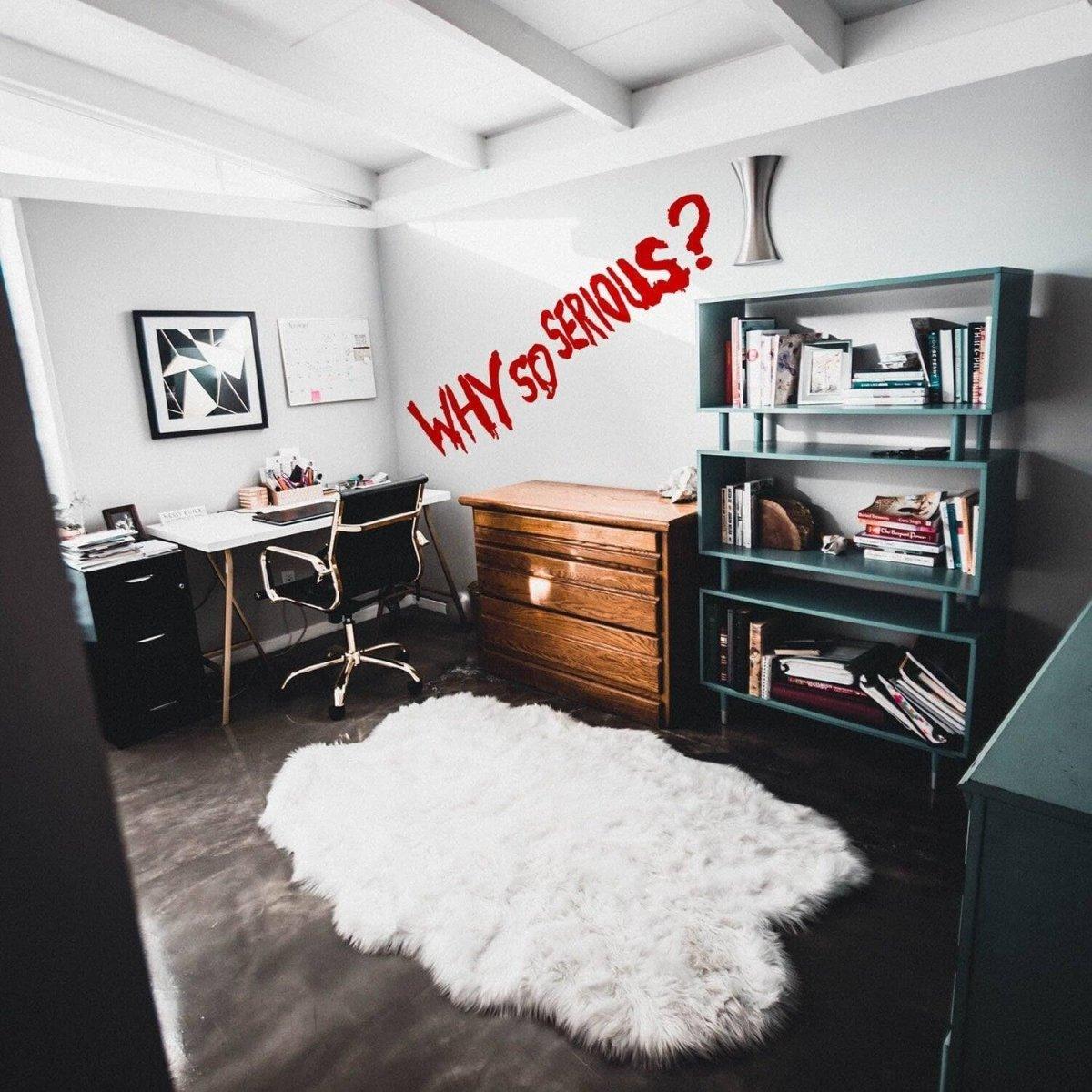 Home office featuring playful 'Why So Serious?' Joker wall decal above a cozy rug and bookshelves.