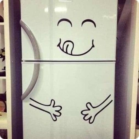 Playful vinyl die cut sticker on a kitchen fridge, featuring a smiling face and playful hands design.