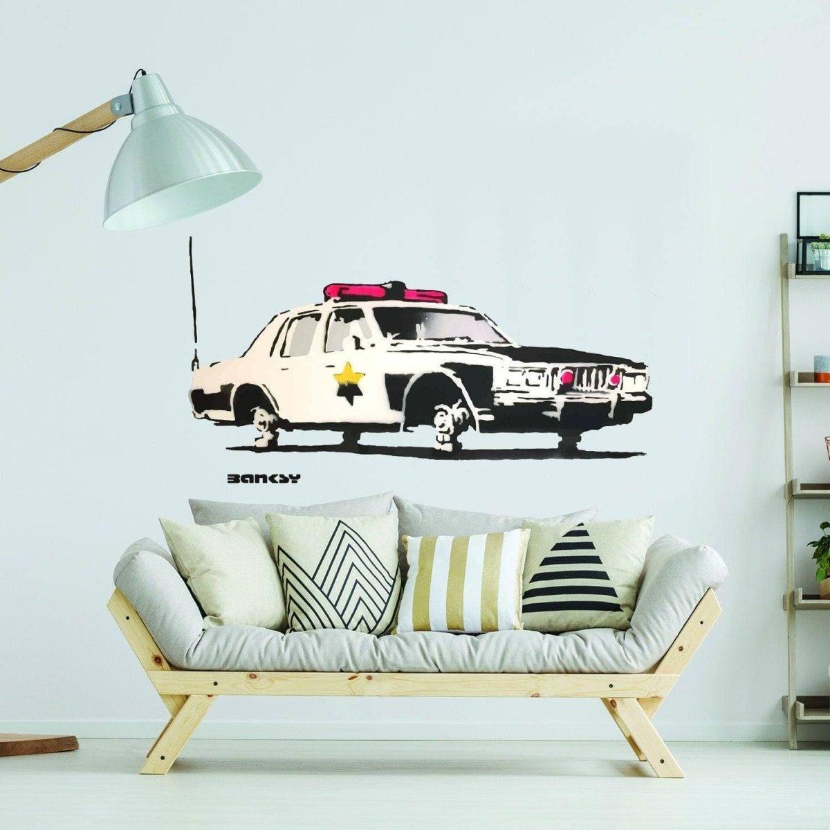 Police car wall sticker decor above a couch, perfect for kids' rooms or themed spaces.