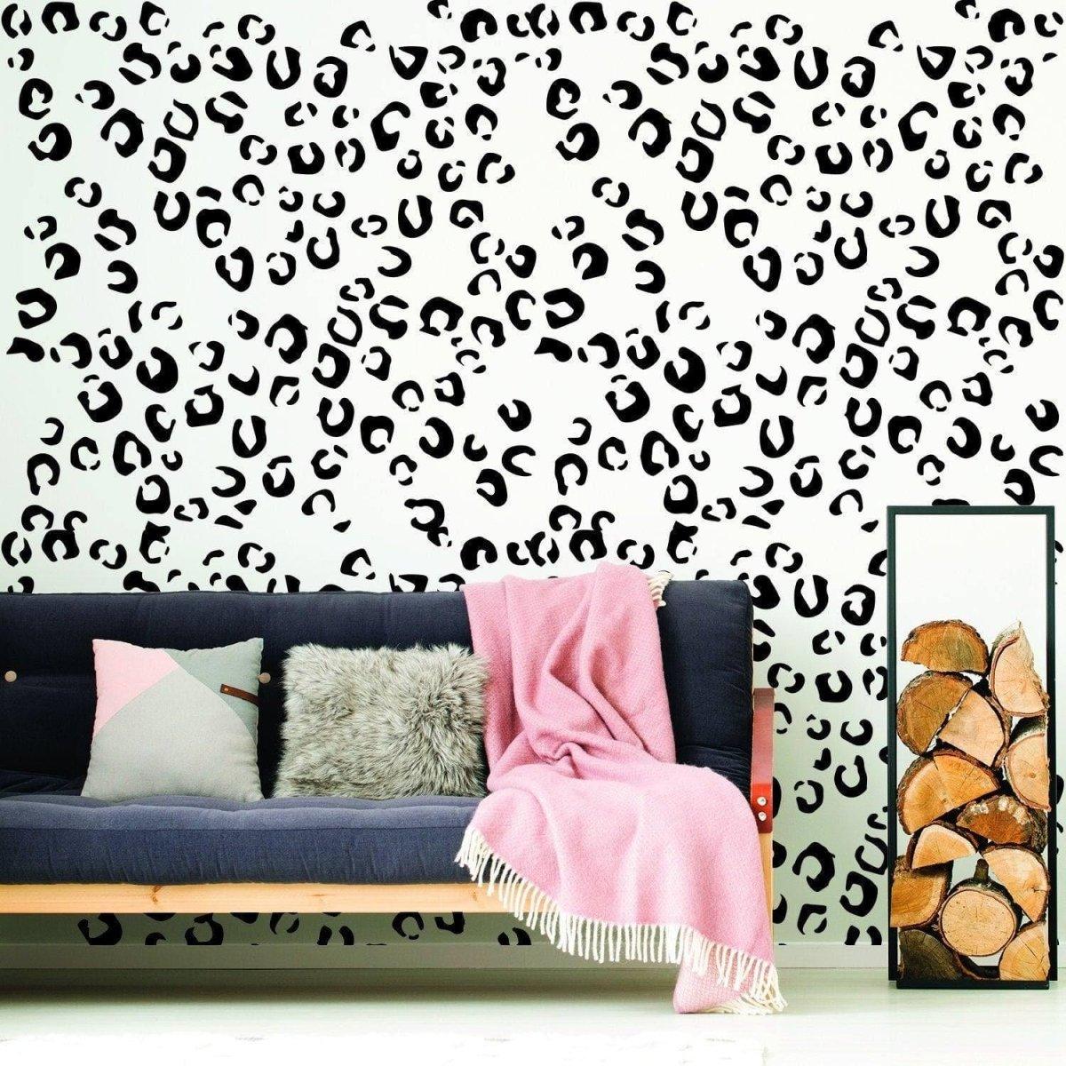 Leopard spot vinyl decals on a wall, enhancing a cozy living room with stylish decor and a pink throw blanket.