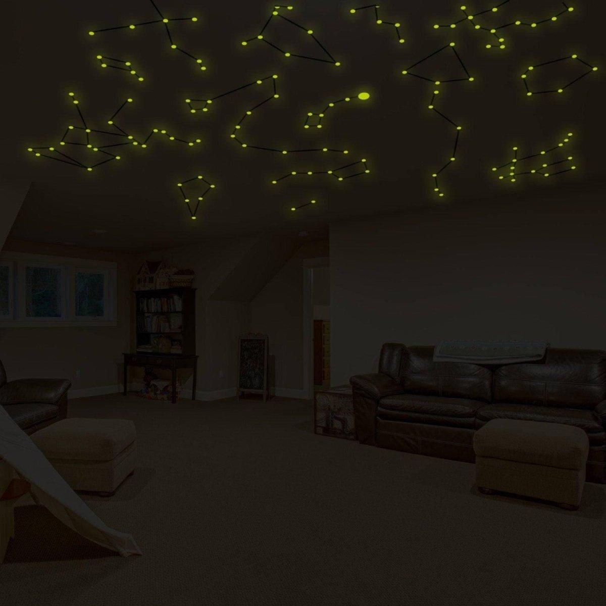 Glow-in-the-dark constellation decals illuminating a cozy room ceiling, creating a starry night sky effect.