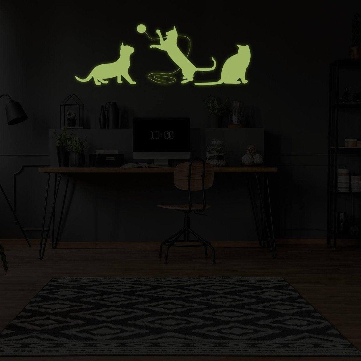Glow in the dark feline wall decal featuring playful cats, perfect for a magical home ambiance.