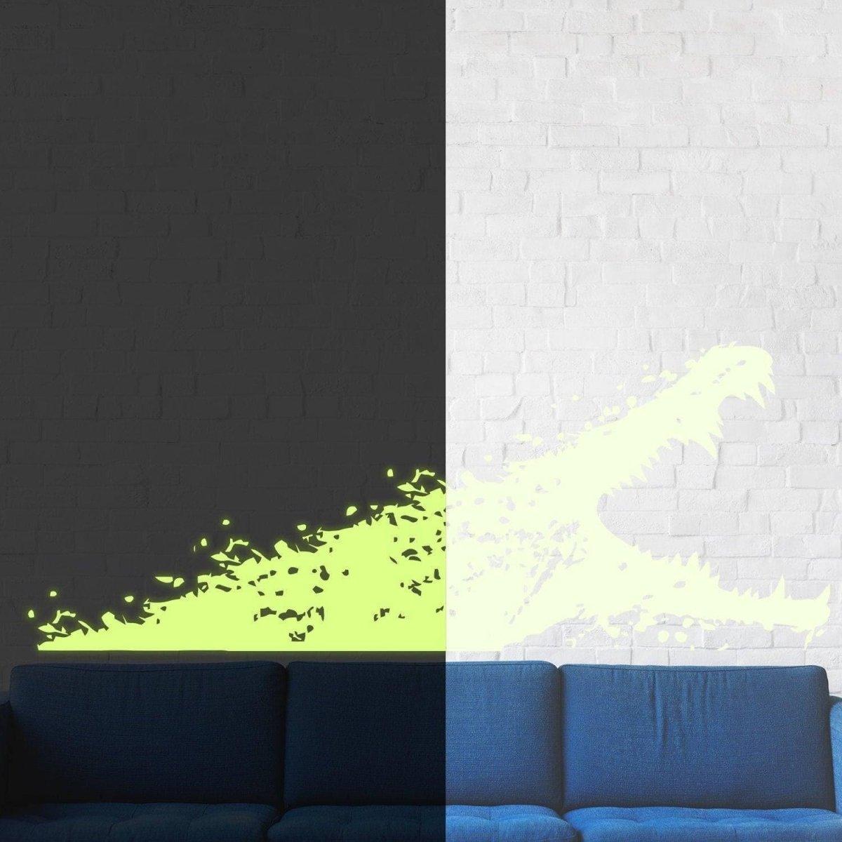 Glow-in-the-dark alligator wall decal displayed on a wall next to a blue sofa in a stylish kids' room.