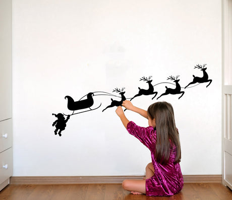 Santa sleigh and reindeer wall decal shown in an alternate seasonal interior view.
