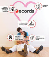 Couple sitting on the floor illustrating key features of Decords wall stickers: easy installation, waterproof, and removable.
