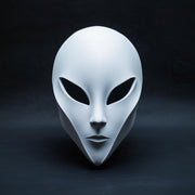Minimalist 3D printed alien mask with an elongated face shape and large dark eye openings.