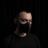 Minimalist black half-face mask worn by a man, showcasing its sleek design and modern style.