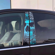 Close-up of a car’s B-pillar with a vivid blue skull and rose decal applied to both window pillars, viewed from the side.